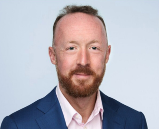 Portrait picture of Jonathan Brown wearing a suit